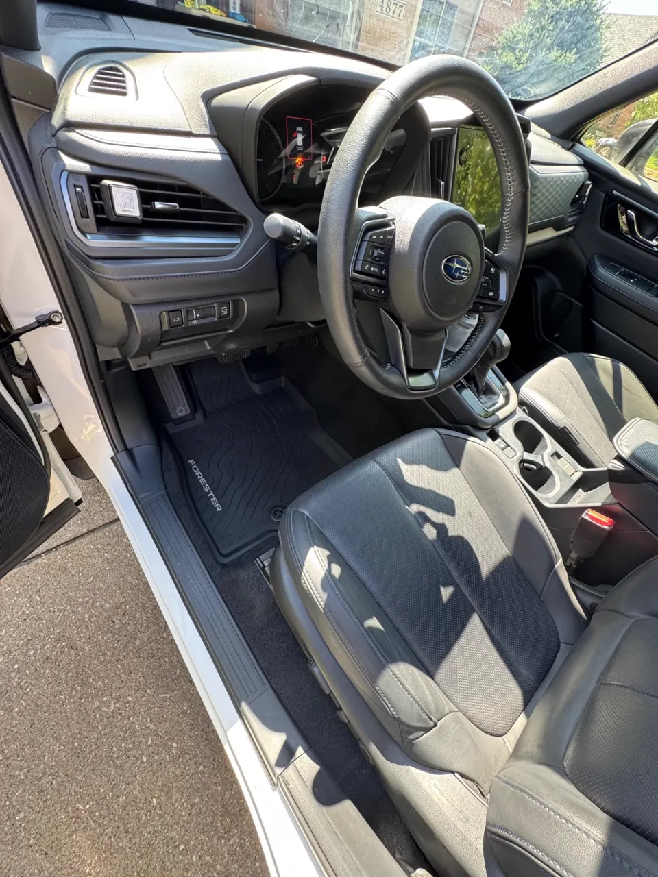 Detailed Subaru Forester driver's side interior with clean dash, console and floor mats
