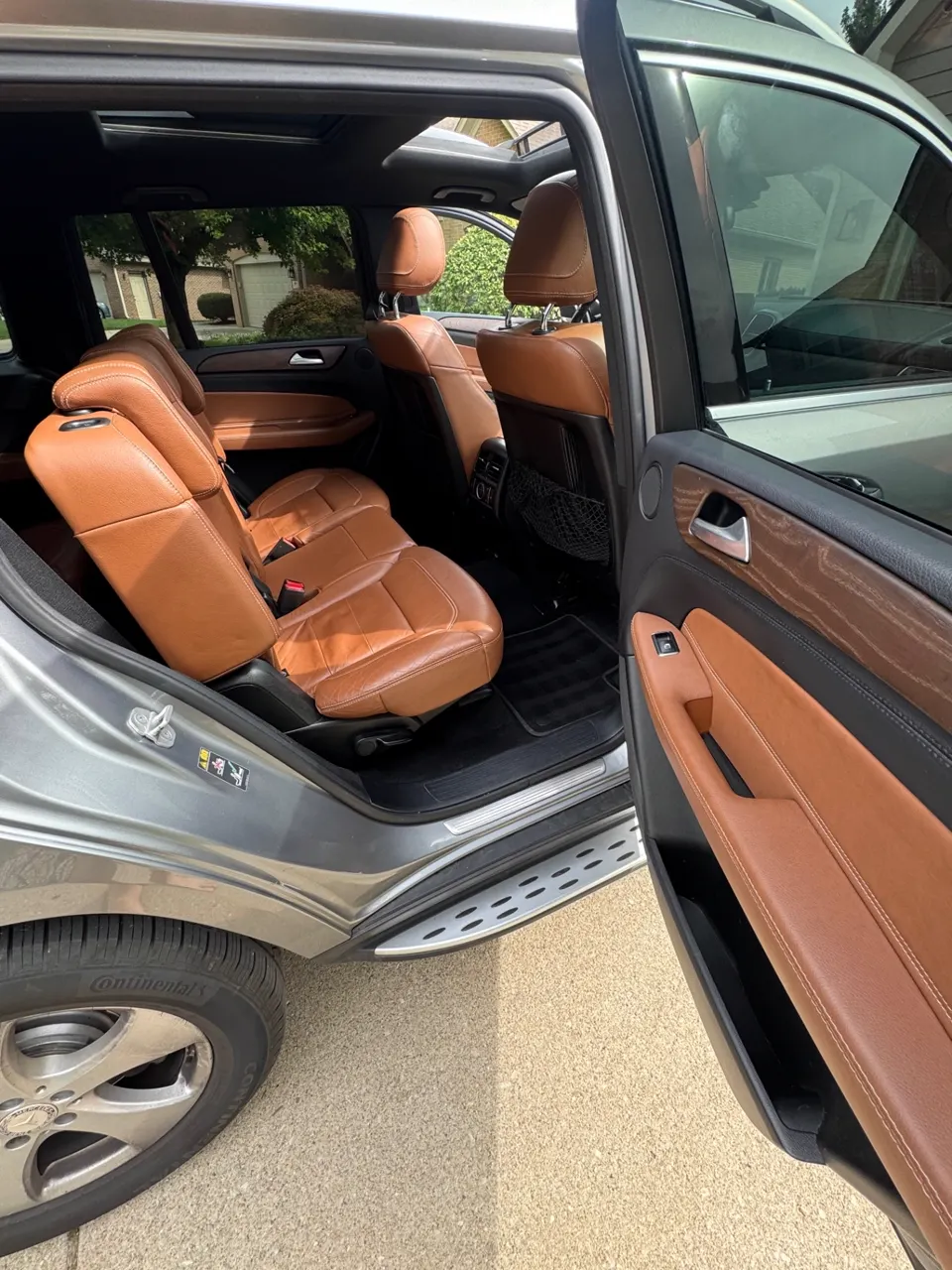 Rear cabin of a Mercedes-Benz GLE after detailing, second-row leather seats and door panel cleaned
